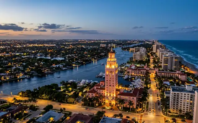 Boca Raton at dusk, the pink tower of The Boca Raton resort between the Intracoastal Waterway and the beachfront high-rises