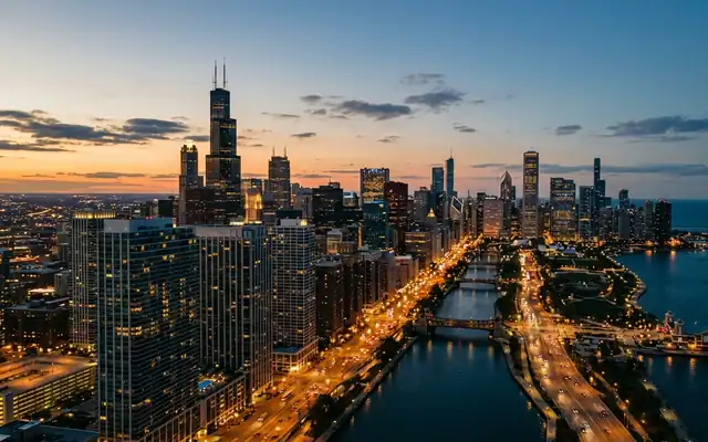 The Willis Tower and Chicago skyline along the waterfront meeting Lake Michigan at dusk