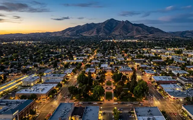 Concord at dusk, the green square of Todos Santos Plaza in the downtown grid with Mount Diablo on the horizon