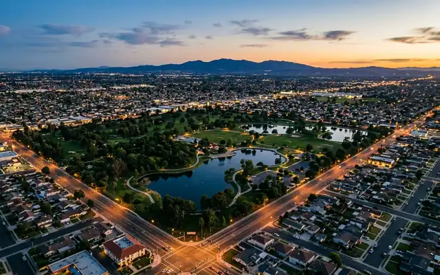 Fountain Valley at dusk, the lakes and green expanse of Mile Square Park ringed by a flat suburban street grid