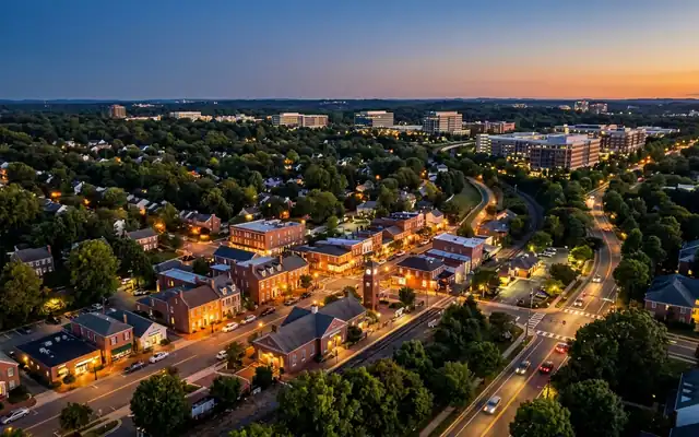Herndon at dusk, the small red-brick downtown with its clock tower amid dense tree cover and leafy Virginia streets