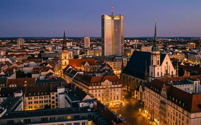 Leipzig city centre at dusk, the City-Hochhaus tower and old town church spires