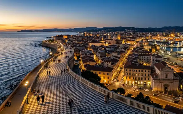 Livorno at dusk, the chequerboard Terrazza Mascagni promenade curving along the seafront with the old town and port behind