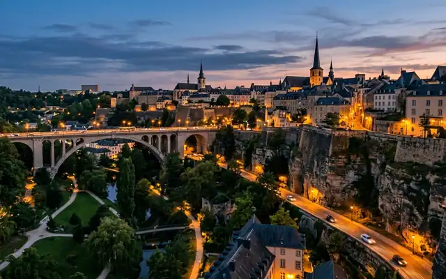 Luxembourg City at dusk, the old town on its cliffs above the Petrusse valley with the arched Adolphe Bridge