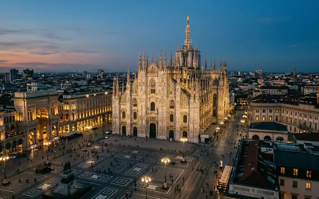 The illuminated Milan Duomo cathedral above Piazza del Duomo at dusk
