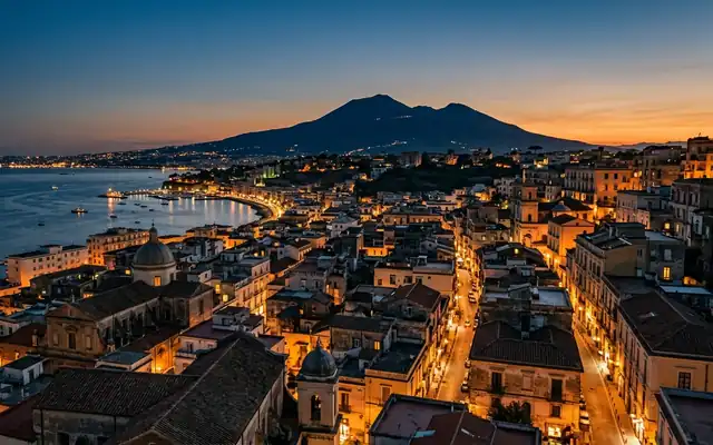 Mount Vesuvius above the rooftops of Ercolano on the Bay of Naples at dusk
