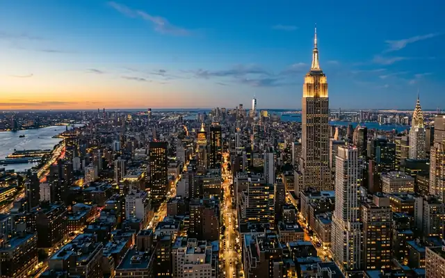 The Empire State Building rising above the dense Manhattan skyline in New York at dusk