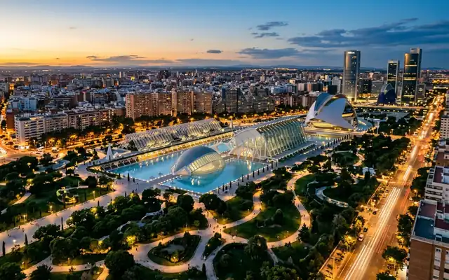 The white City of Arts and Sciences complex in Valencia's green Turia park at dusk