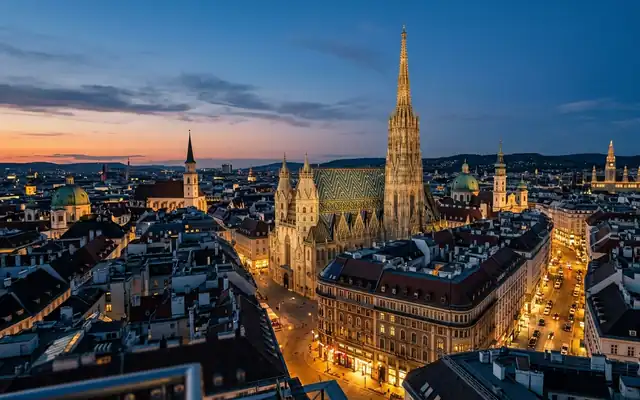 St. Stephen's Cathedral's tiled roof and gothic spire above Vienna's old town at dusk