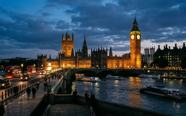 Big Ben and the Houses of Parliament lit at dusk beside the River Thames in London, seen from Westminster Bridge