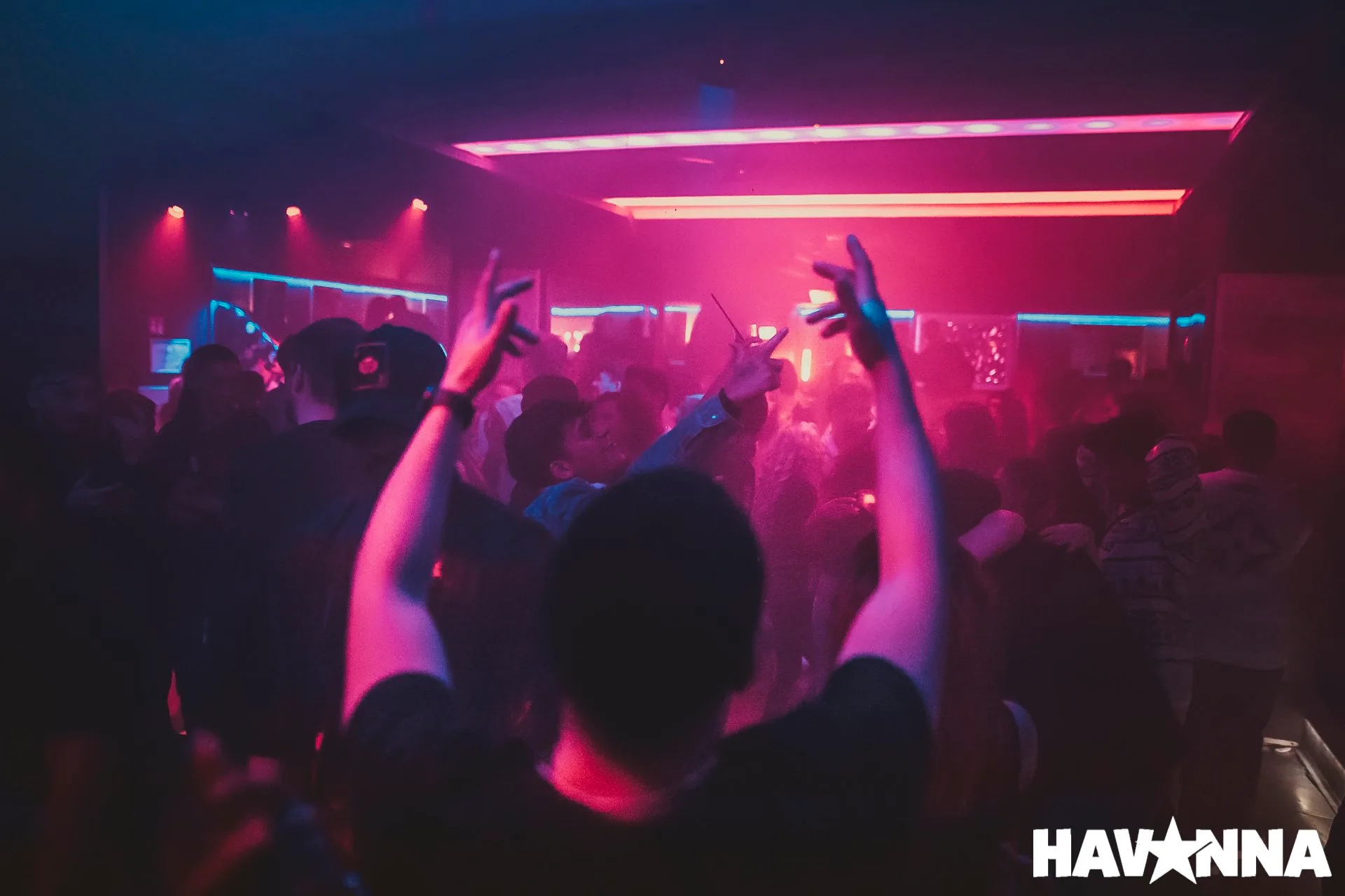 Crowd dancing under purple club lights at Havanna in Berlin