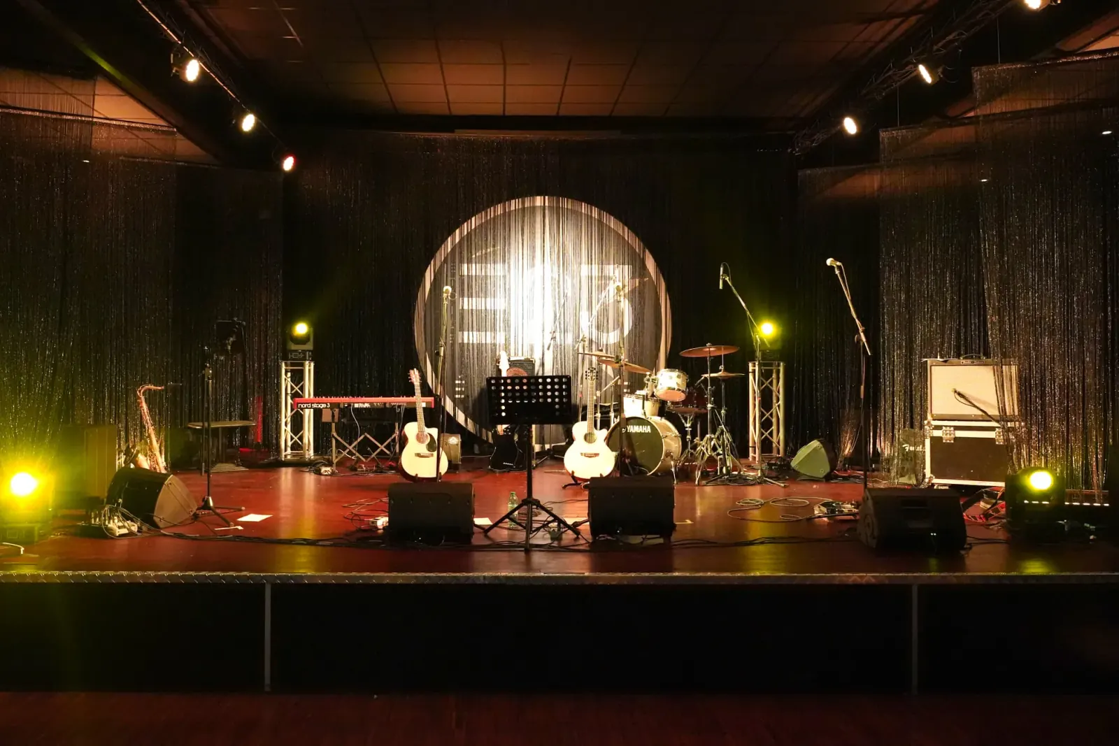 Live band stage setup with instruments at Zanussi music venue in Rome