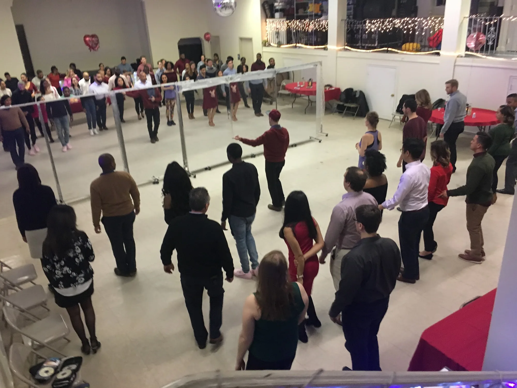 Social dance evening with disco ball and string lights at DanceSport Dupont Circle in Washington