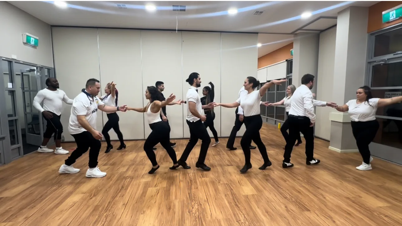 Group of dancers practicing partner work on the wooden floor at La Fiesta Dance Factory in Annandale, Sydney