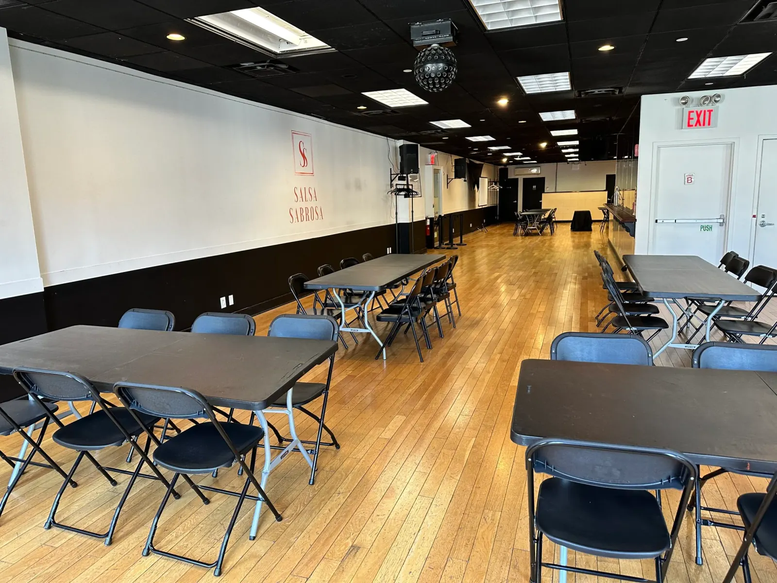 Event hall with wooden dance floor and disco ball at Little Dreams Event Space in New York