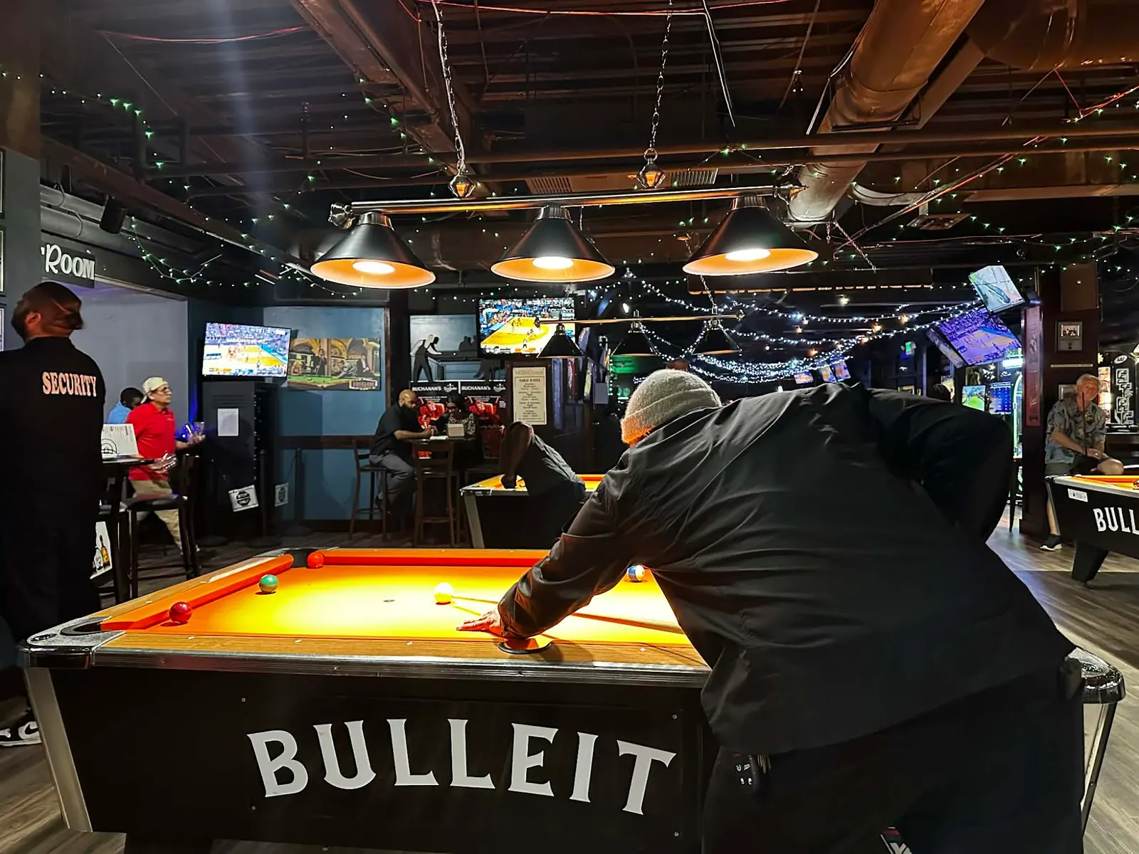Lit pool tables and string lights in the game room at Nottingham’s Tavern in Columbia