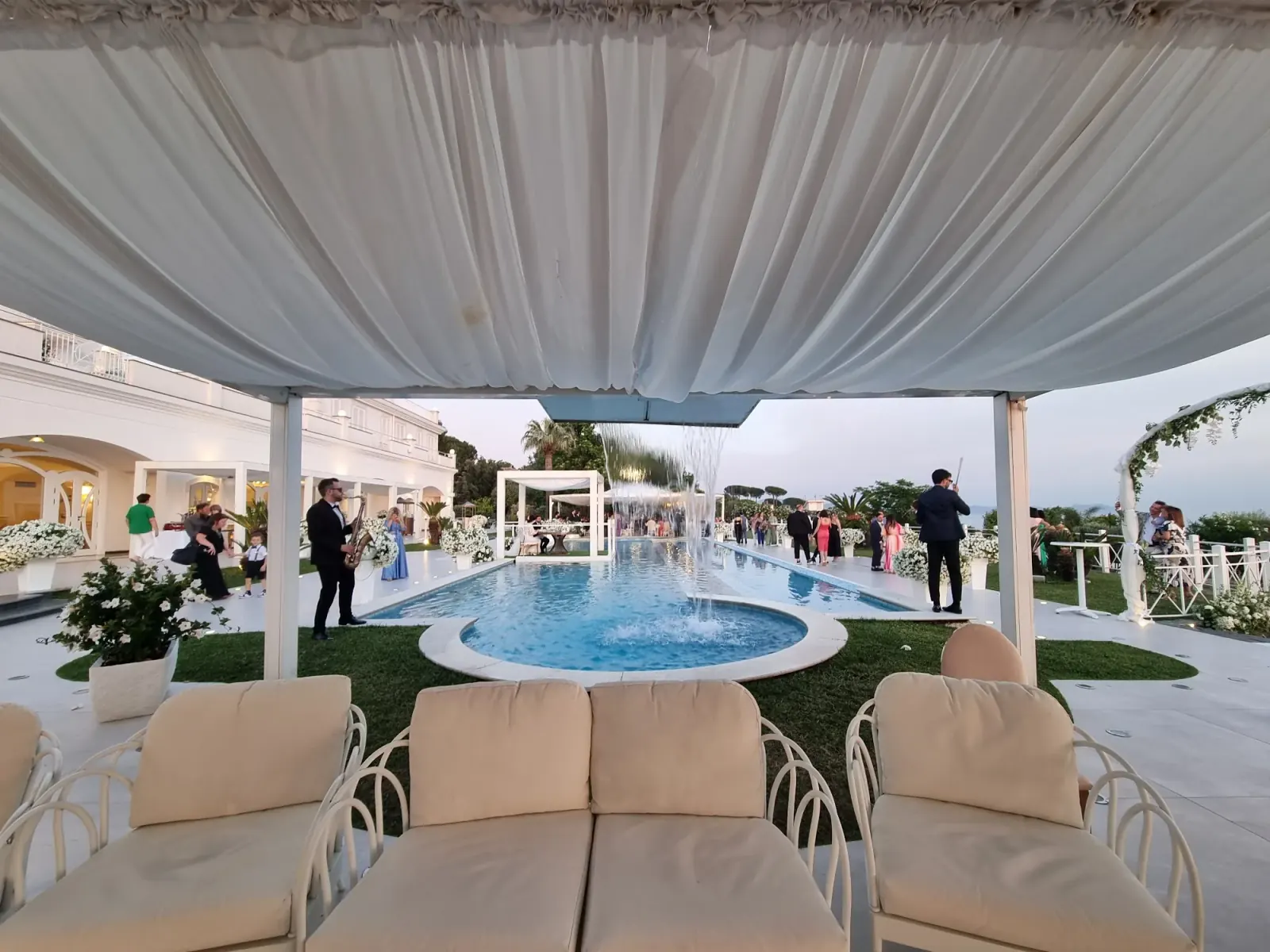 Outdoor poolside event space with guests at Zeno Complex Ercolano Italy