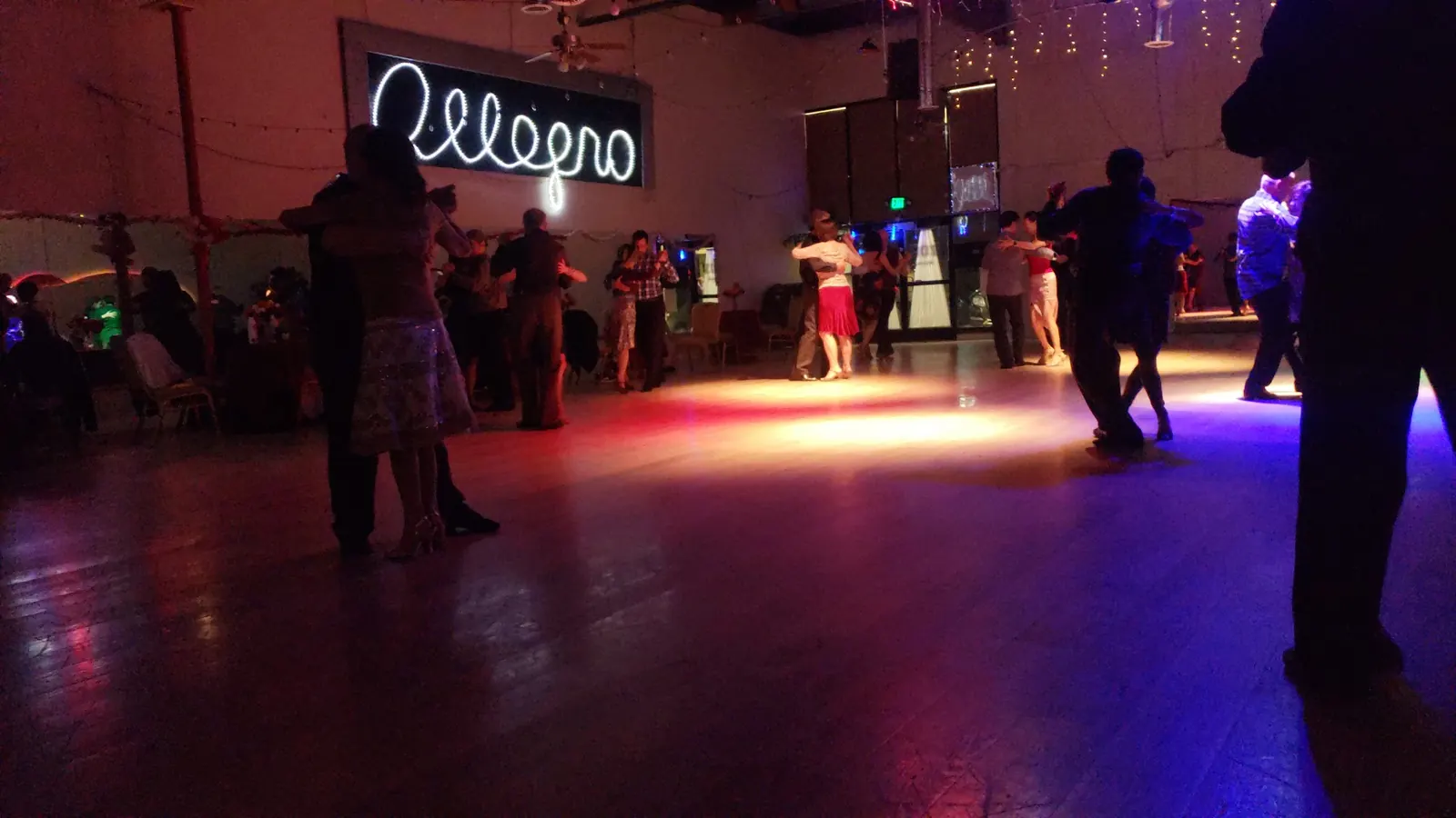 Couples dancing in coloured light on the floor at Allegro Ballroom, San Francisco