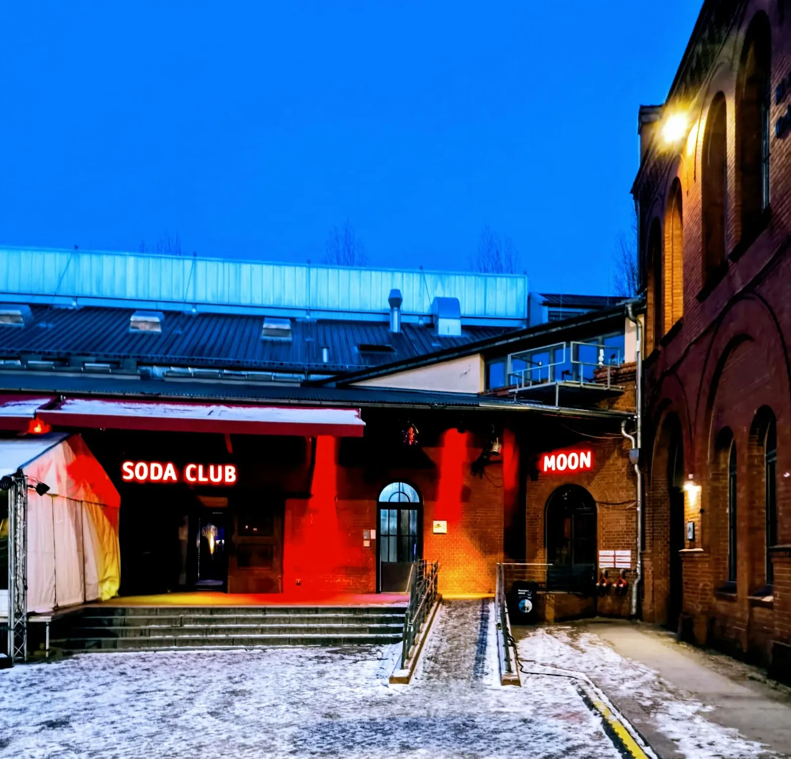 Illuminated SODA CLUB neon signage at the entrance of Soda Social Club Berlin