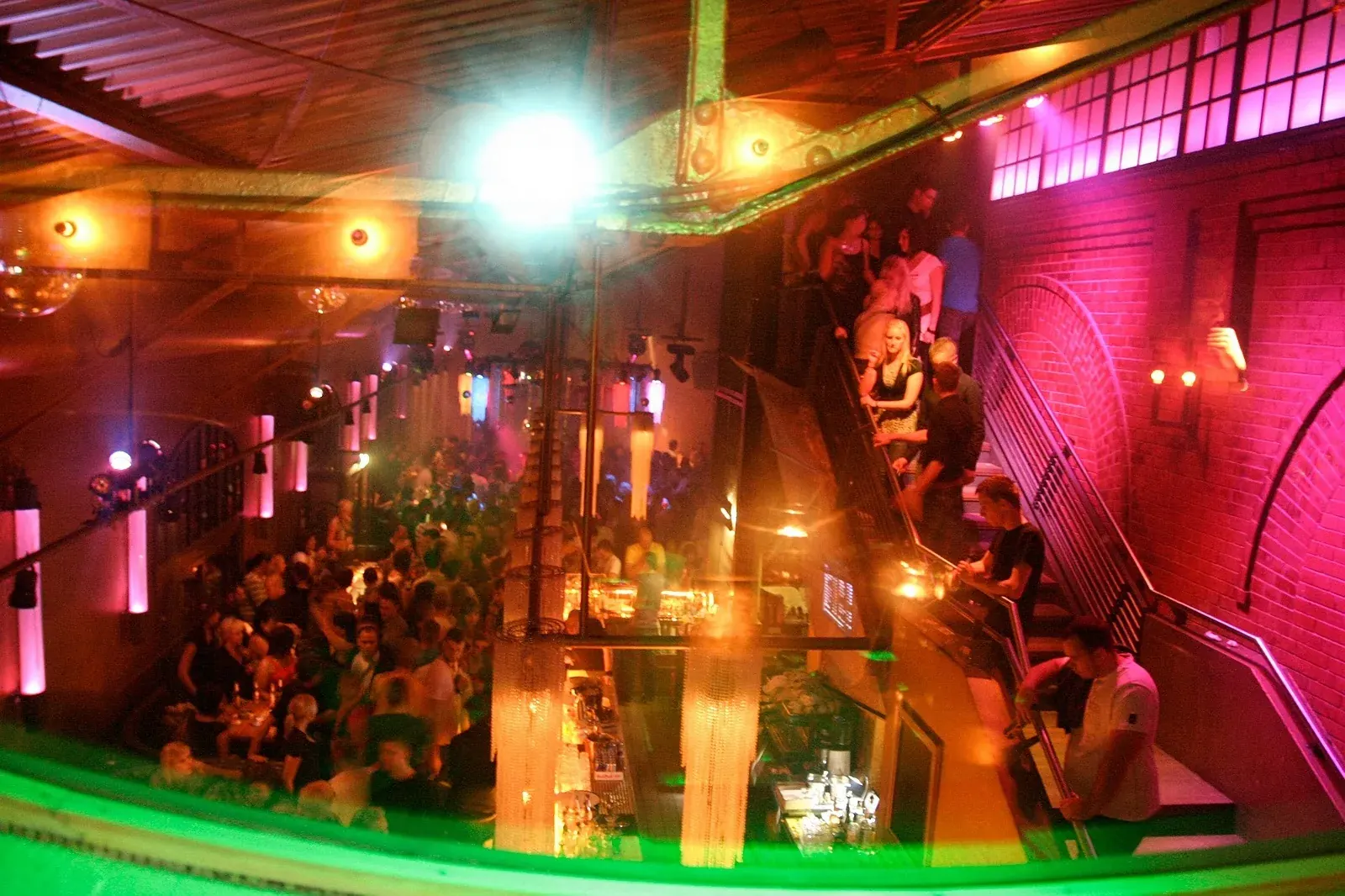Multi-level dance floor with crowd and colorful club lighting at Soda Social Club Berlin