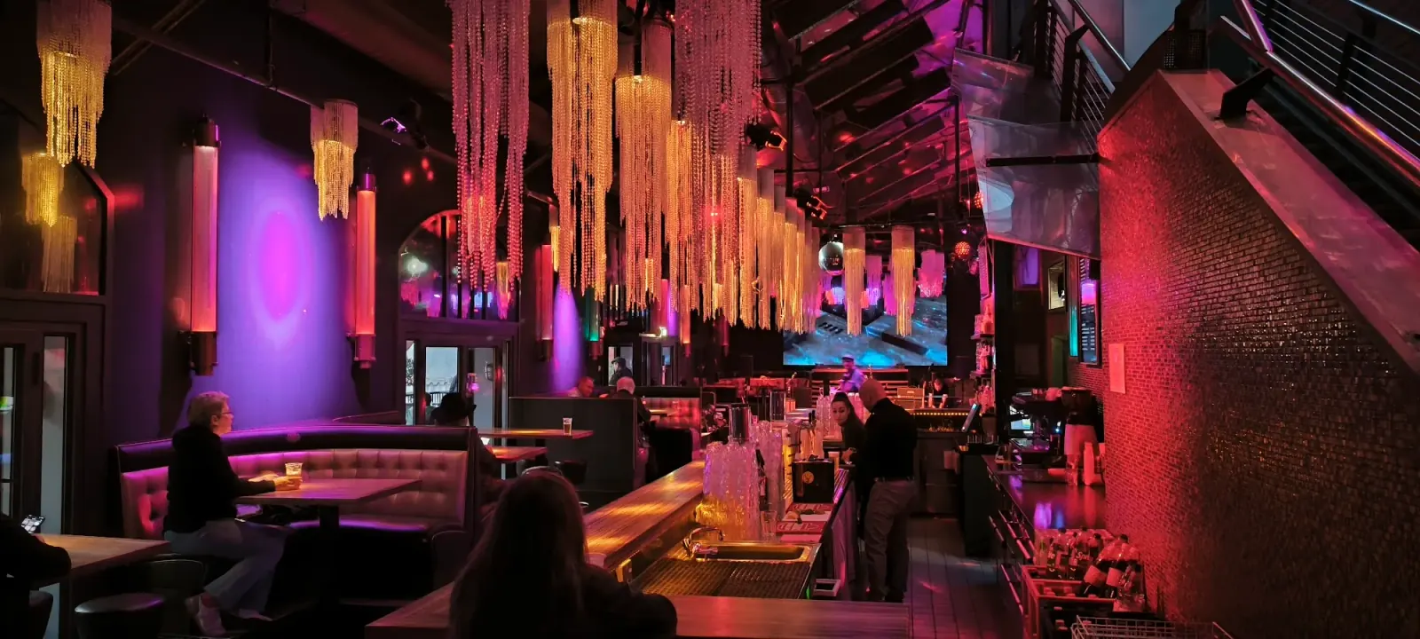 Bar and lounge with chandelier lighting and disco ball at Soda Social Club Berlin