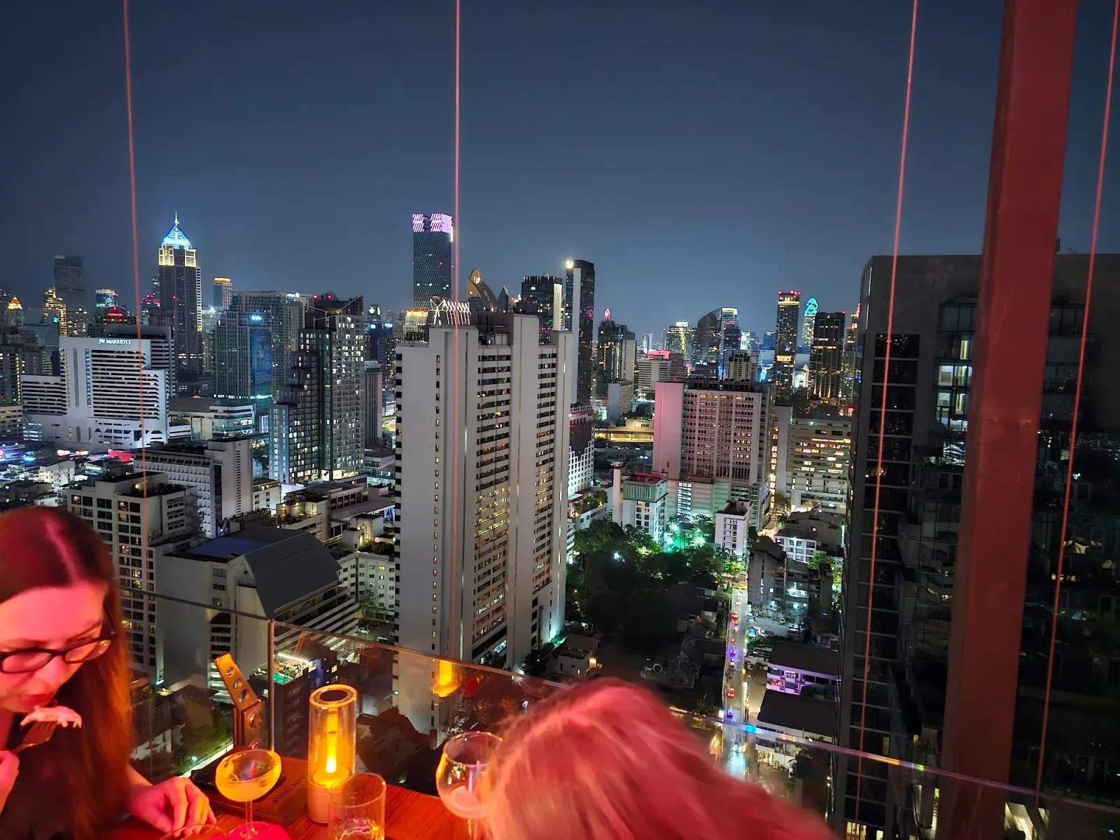 Rooftop bar with panoramic Bangkok night skyline at Above Eleven