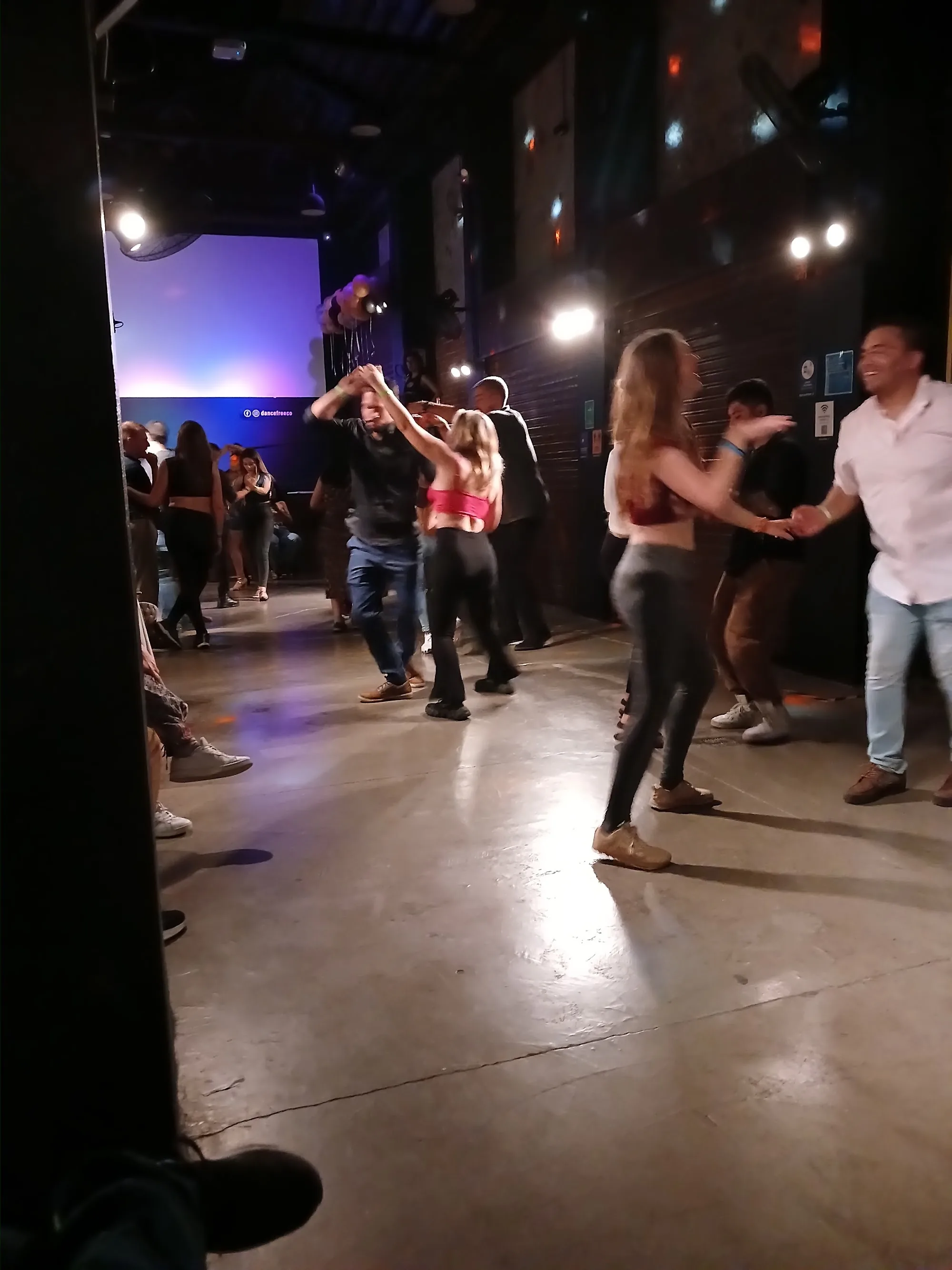 Packed social dance floor with couples dancing at Dancefree Medellin