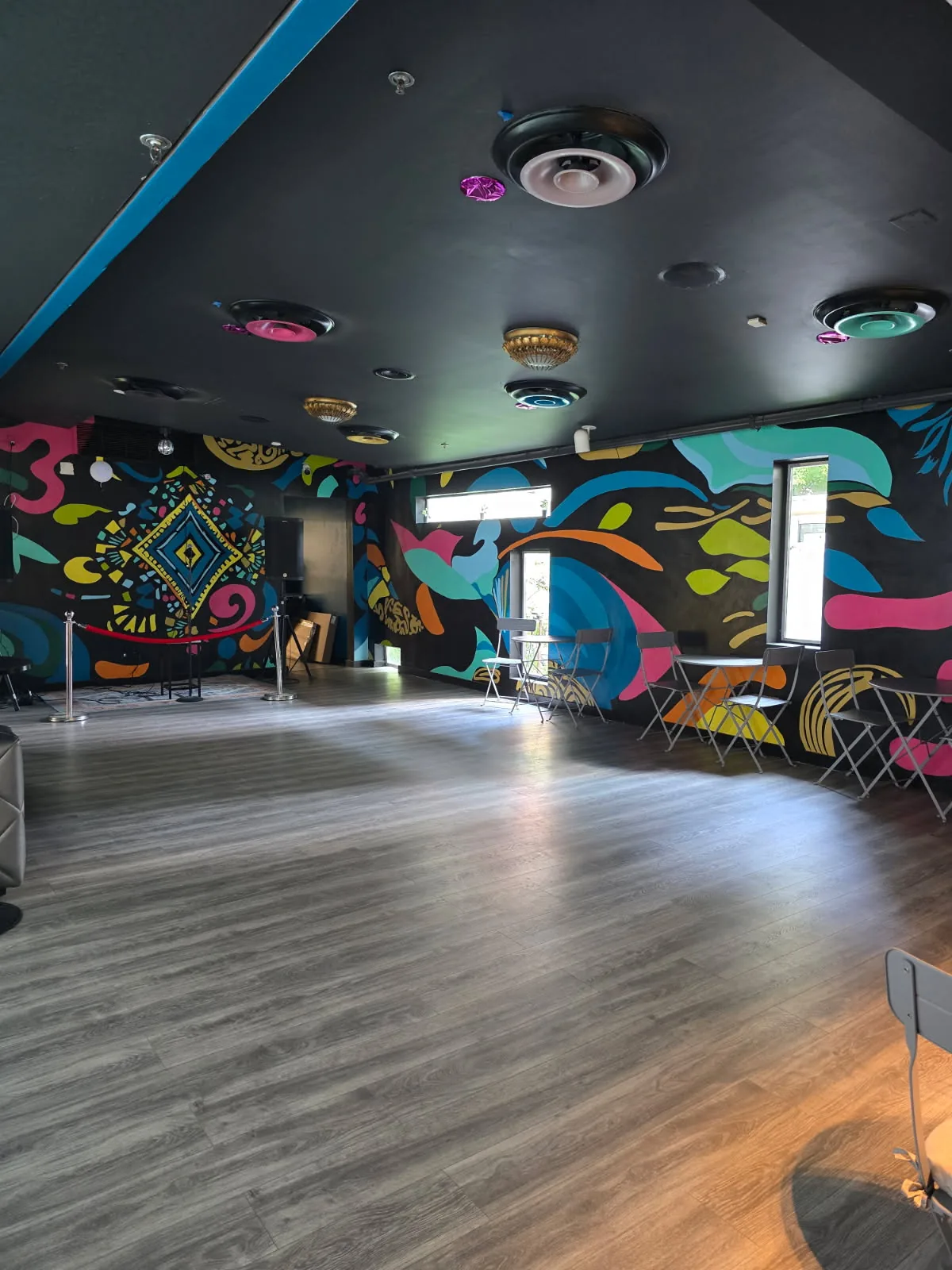 Dance floor with colorful mural walls at Crazy Conchaz Austin Texas