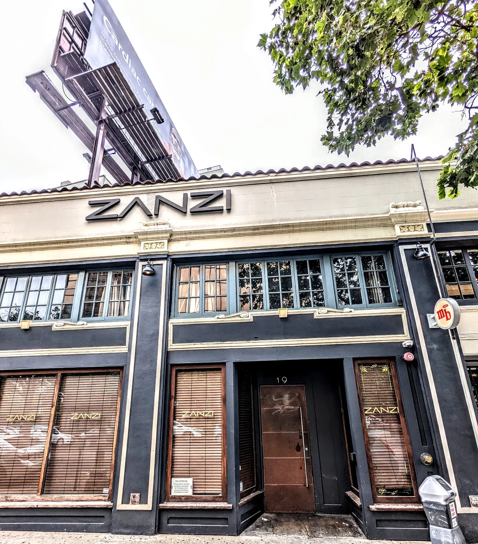 Street facade with the ZANZI sign above the entrance in Oakland