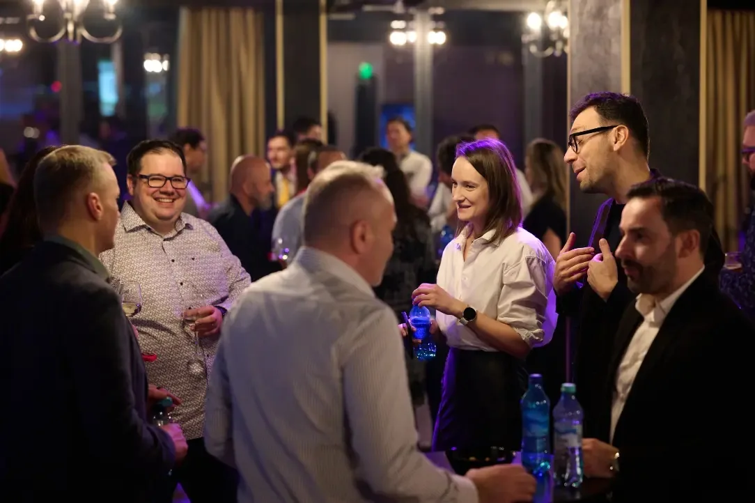 Guests mingling under purple lights at Mille 18 Events social night in Bucharest