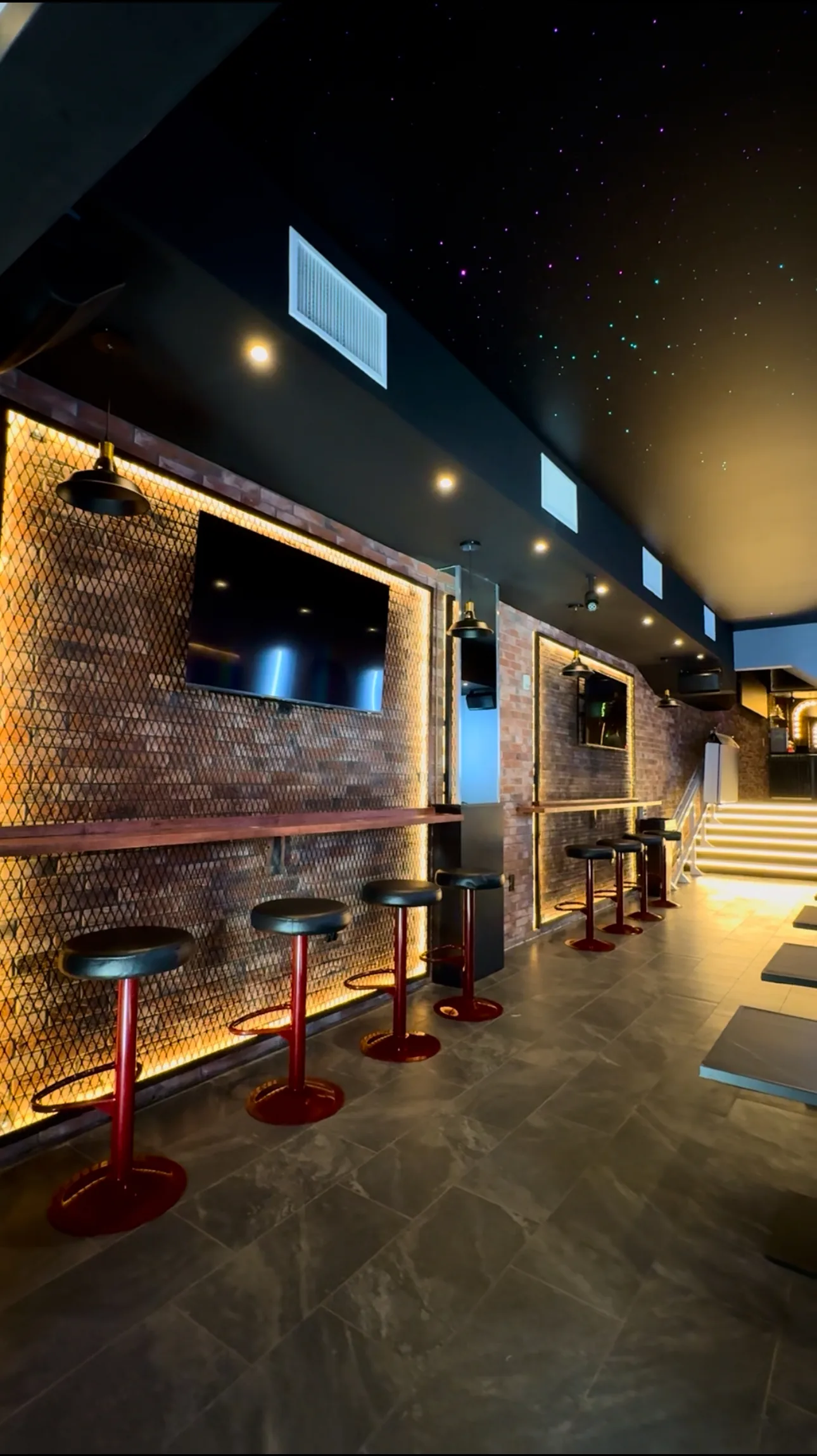 Lucky Bar interior in Washington DC with red bar stools and starry-night ceiling lighting