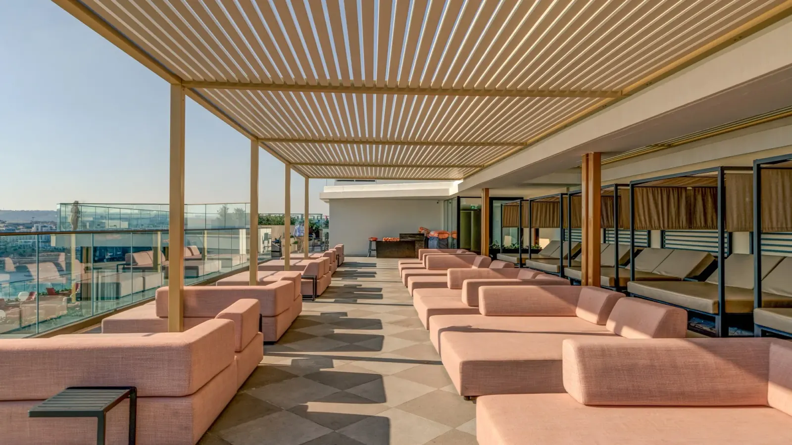 Rooftop terrace with pink sofas and sea view at AX Hotels Malta
