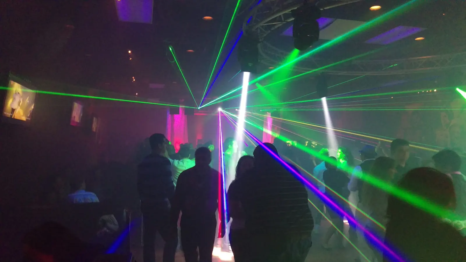 Crowd under laser lights on the dance floor at The Salsa Room in Washington