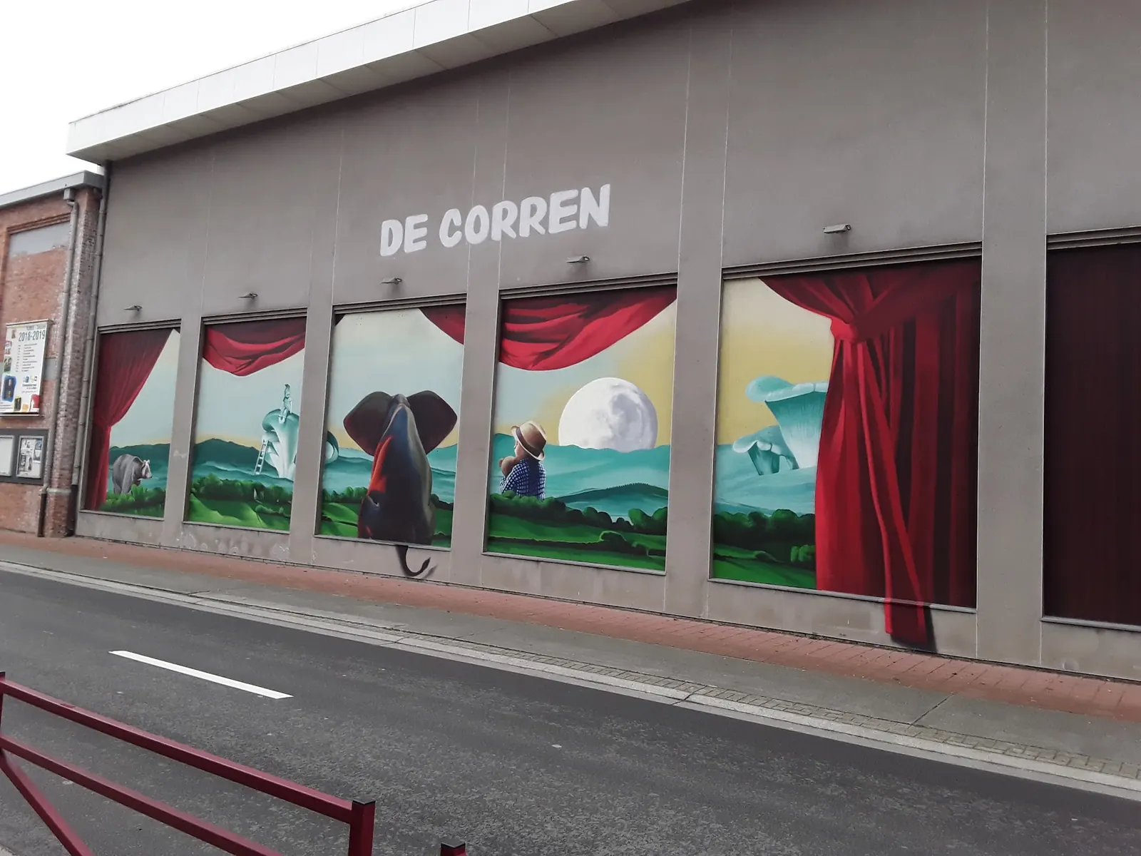 Painted theatre curtain murals and the De Corren name on the street facade in Brussels
