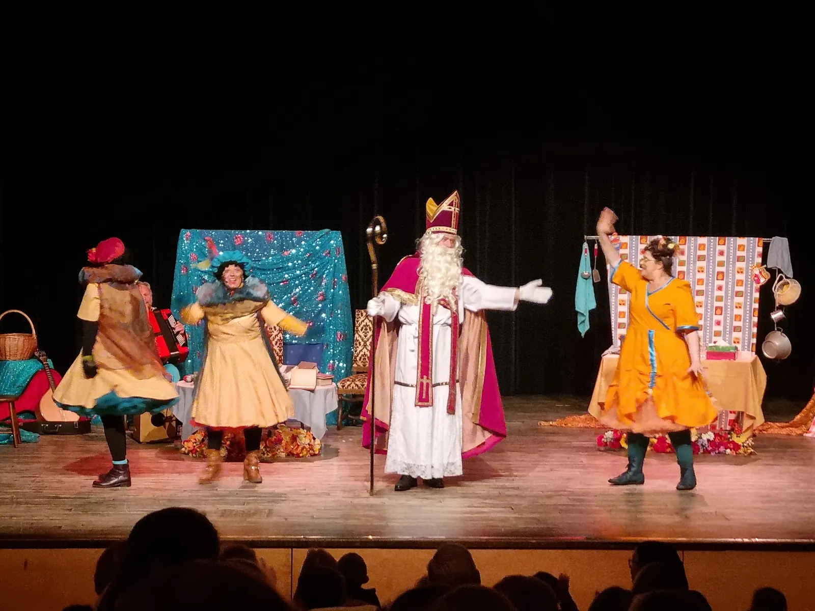 Costumed performers on the stage at GC De Corren in Brussels in front of an audience