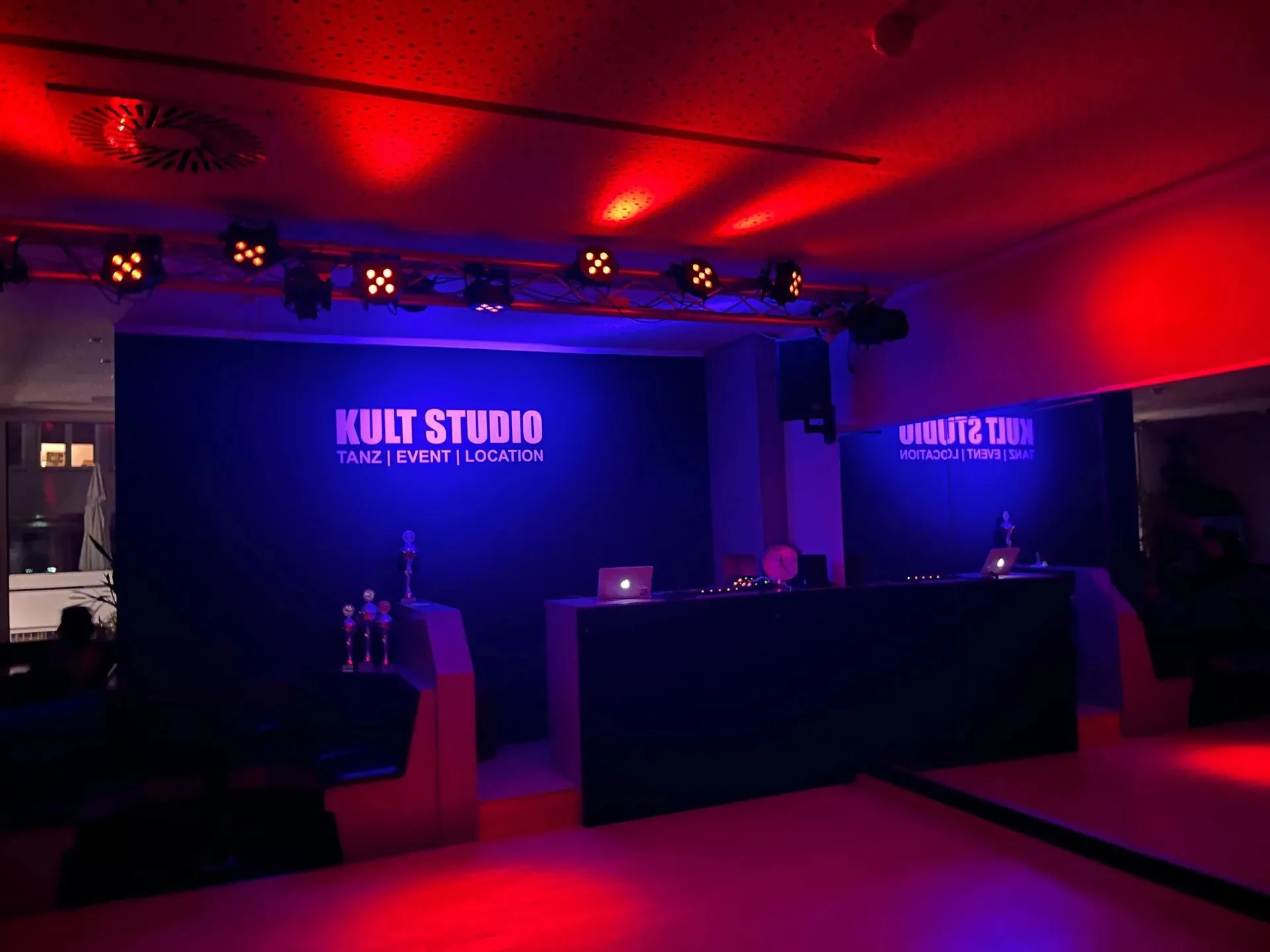 Kult Studio Munich event stage with DJ booth and red and blue club lighting