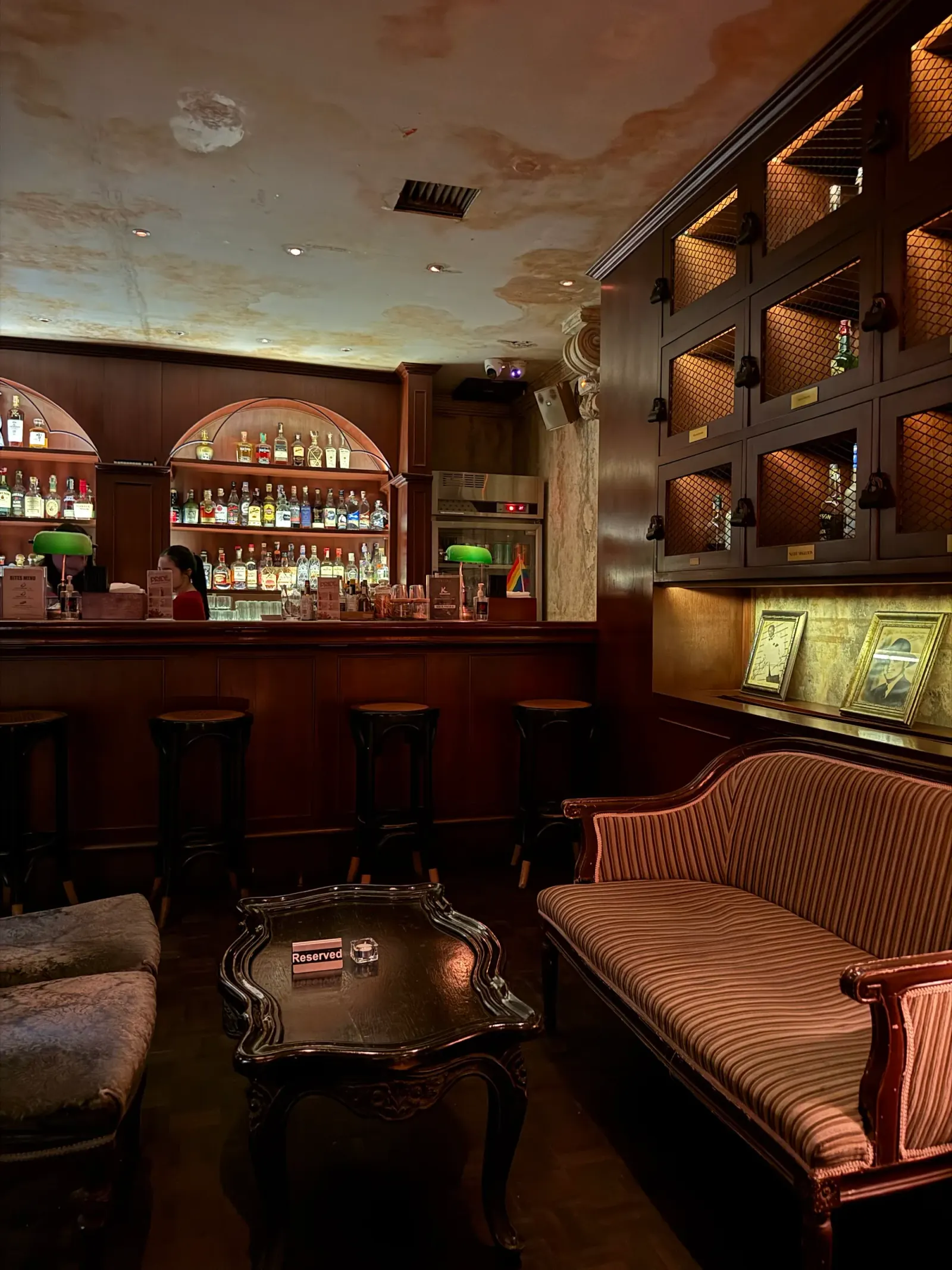 Intimate lounge seating area with dark wood and vintage decor at Havana Social Bangkok