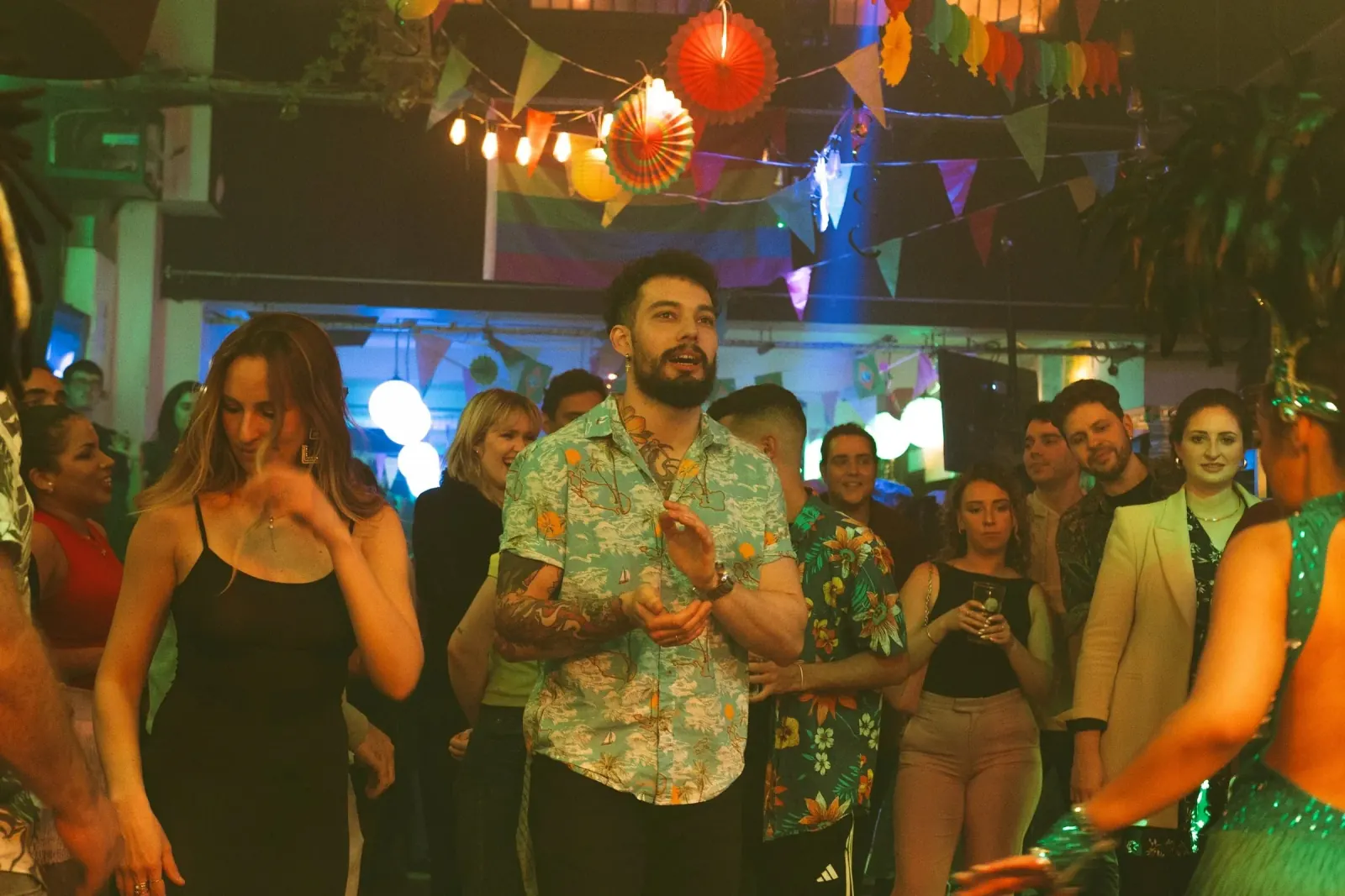 Guests dancing at a lively carnival-themed party night at Wigwam nightclub in Dublin with colorful decorations and festive atmosphere