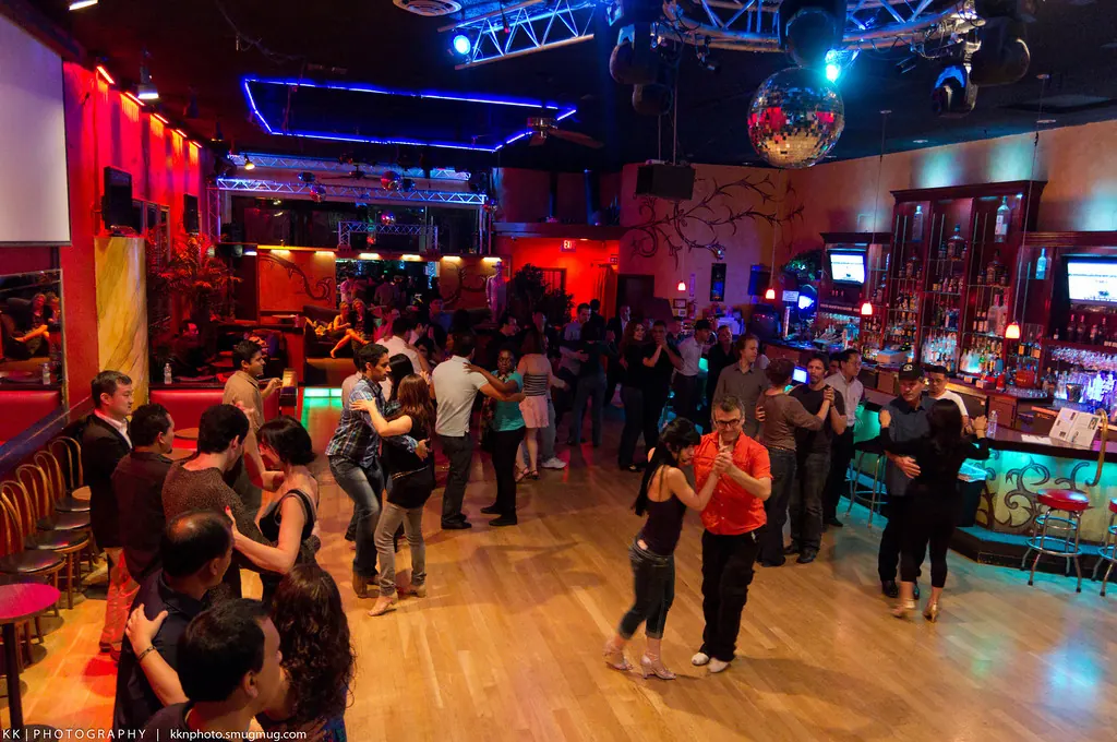 Couples social dancing on the wooden dance floor at Alberto's Night Club