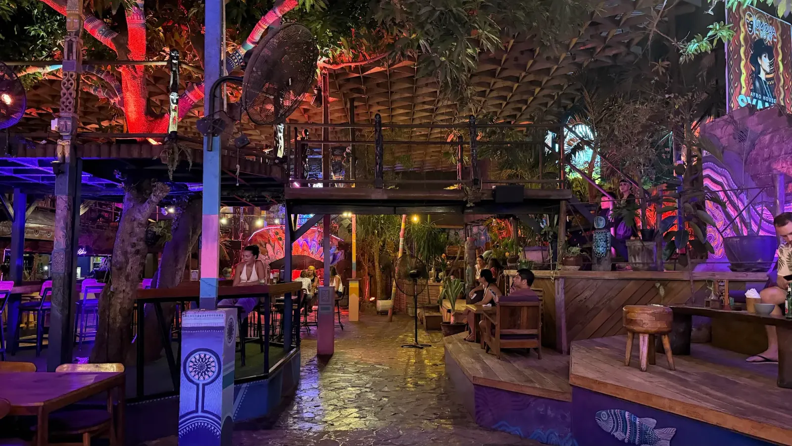 Night-time lounge and bar area with neon lighting at Hatch Bar in Bali