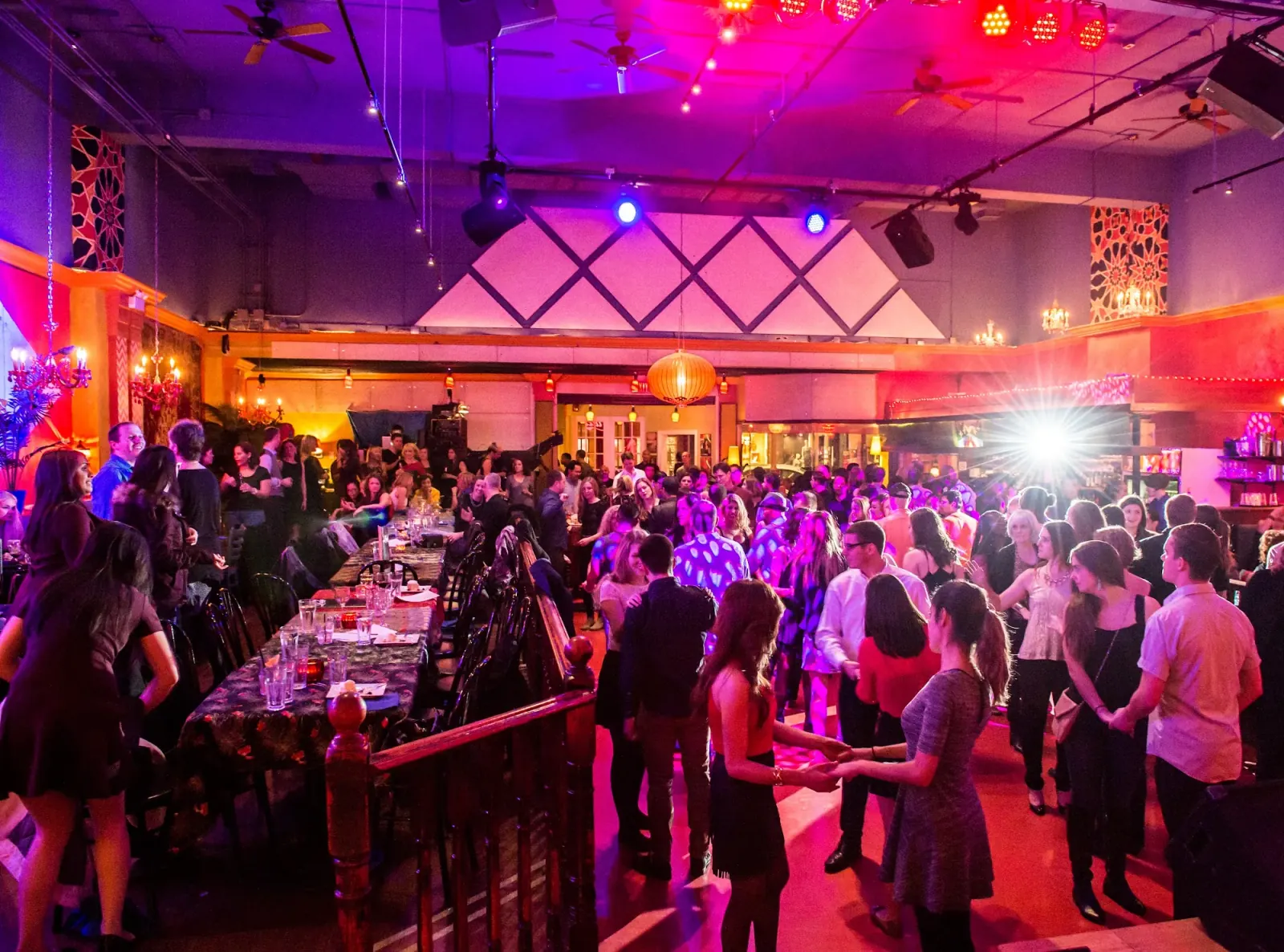 Crowded dance floor with colorful lights and live stage at Lula Lounge Toronto