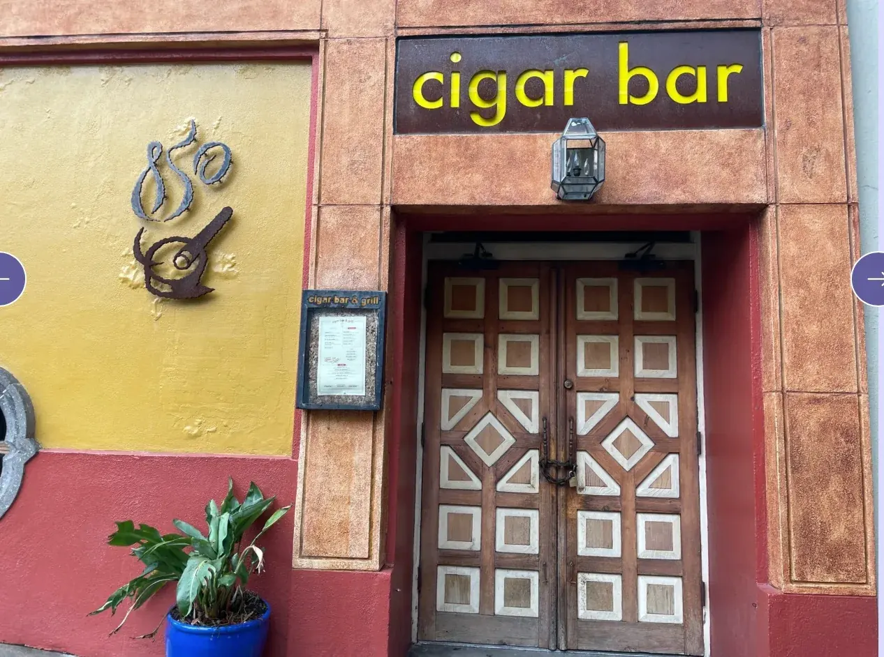 Cigar Bar & Grill exterior entrance with branded yellow signage in San Francisco