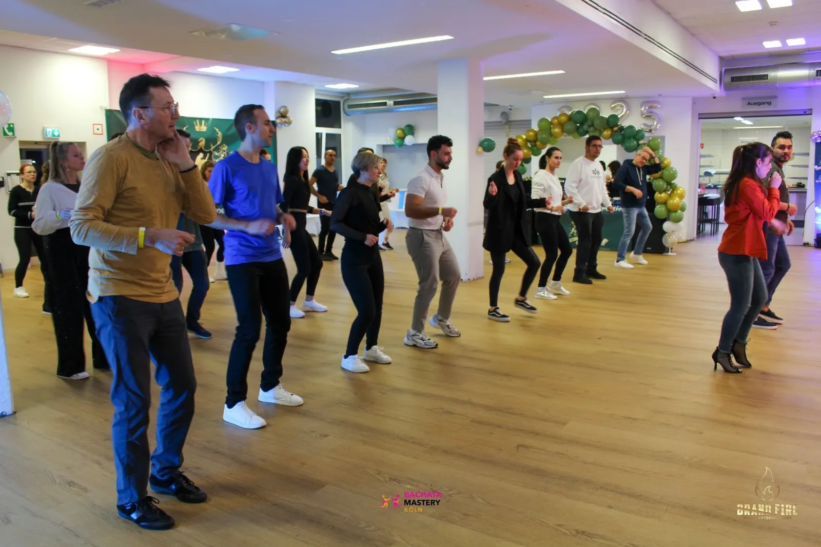 Dancers practising in rows on the wooden floor at Salsa Koeln, Cologne