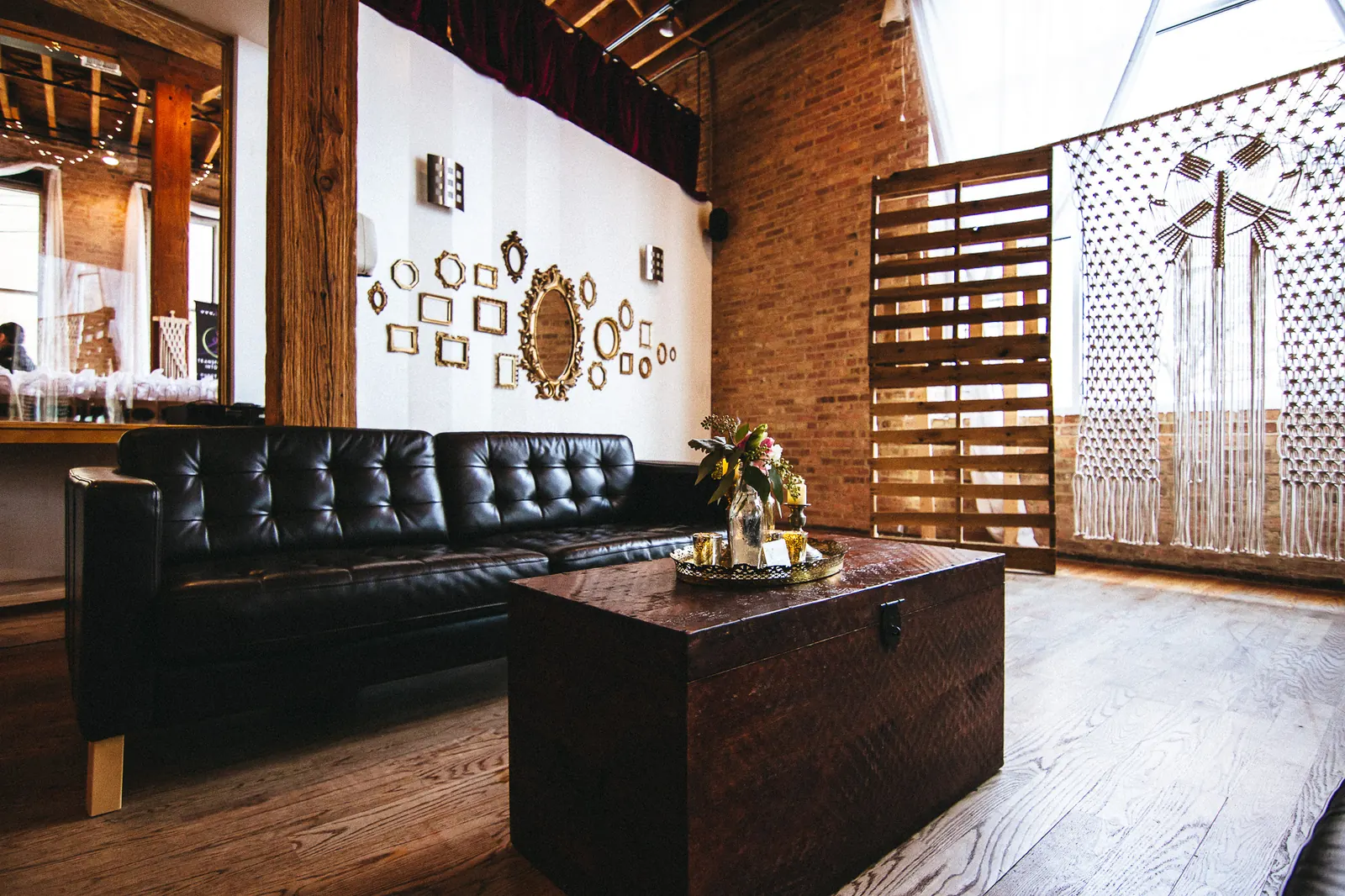 Lounge with leather sofa and exposed brick at Latin Rhythms Academy in Chicago