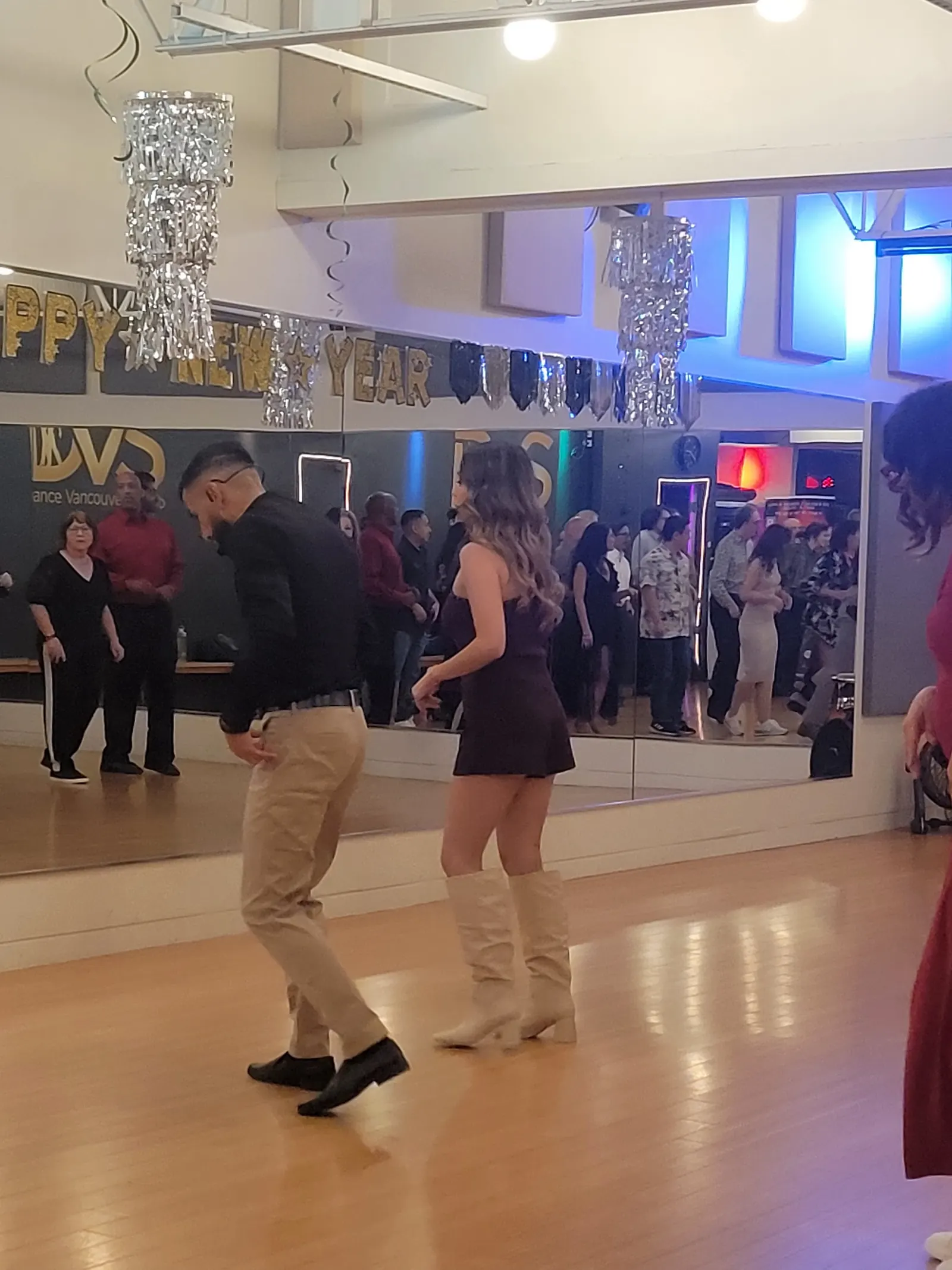 Dancers on the floor under New Year decorations at Dance Vancouver Studio