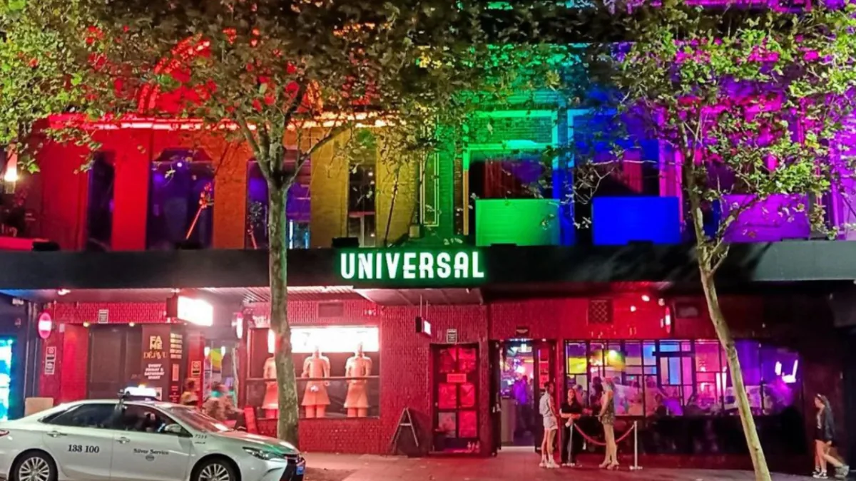 Universal Sydney venue exterior at night with rainbow lighting and signage in Oxford Street