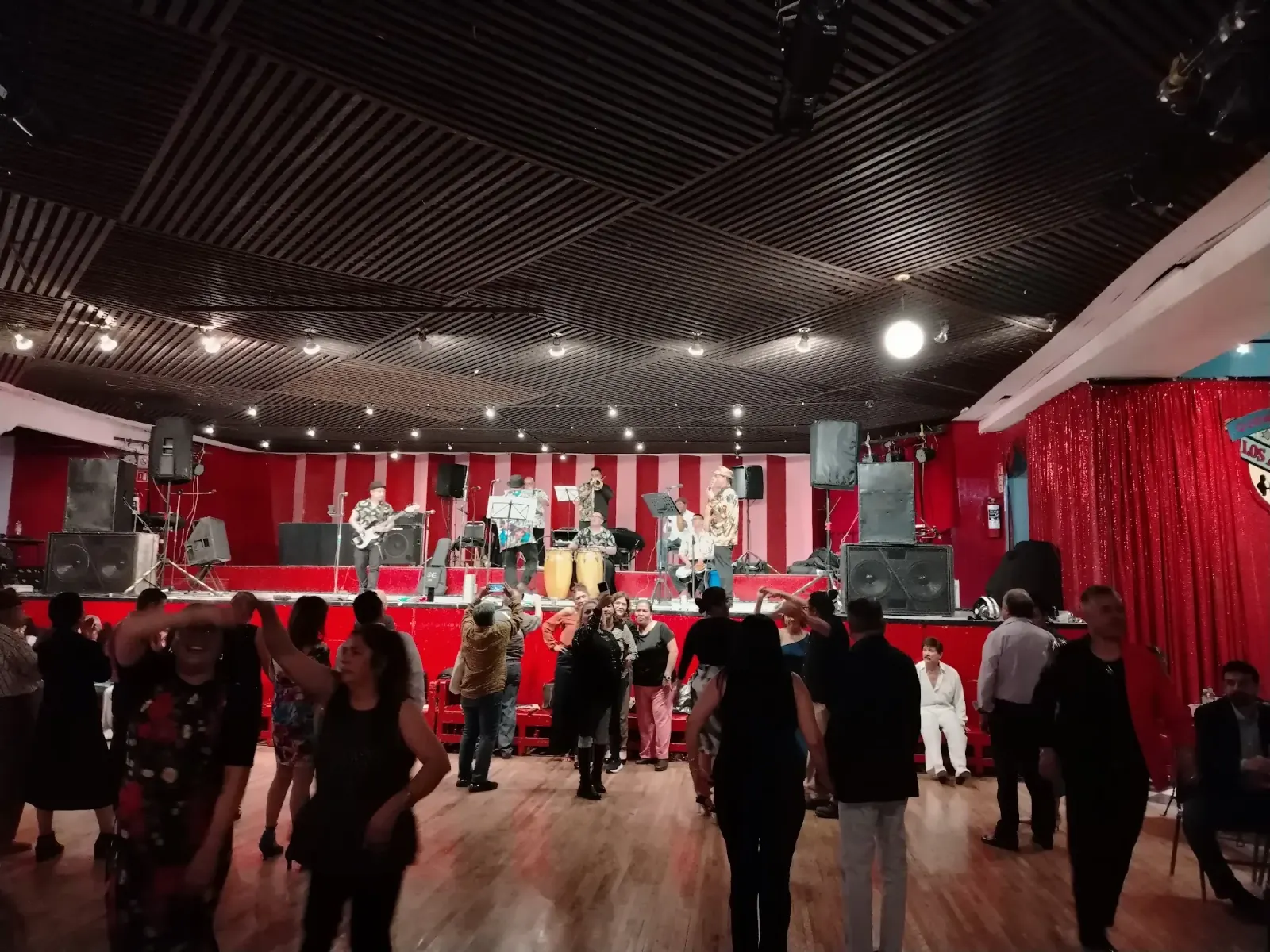 Live salsa band on stage with dancers and crowd at Salón Los Ángeles Mexico City