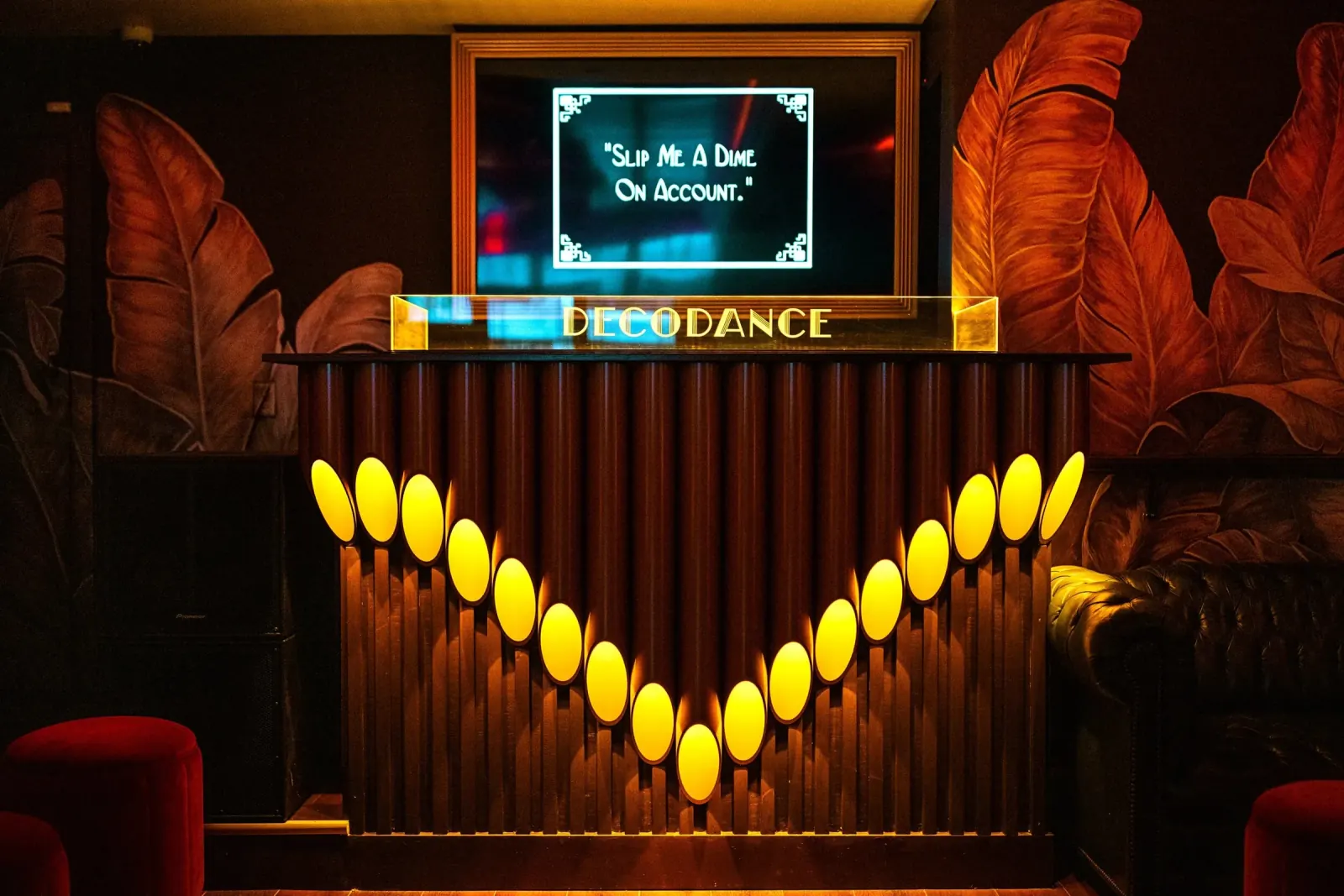 Art deco DJ booth with DECODANCE signage at DecoDance Bar in San Francisco