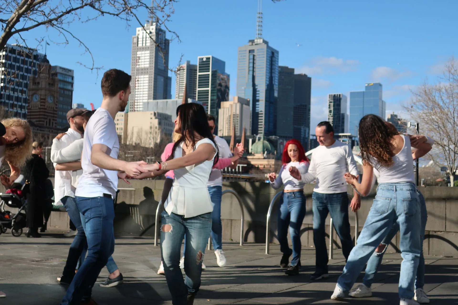 Dance IM social dancing outdoors with Melbourne city skyline in the background