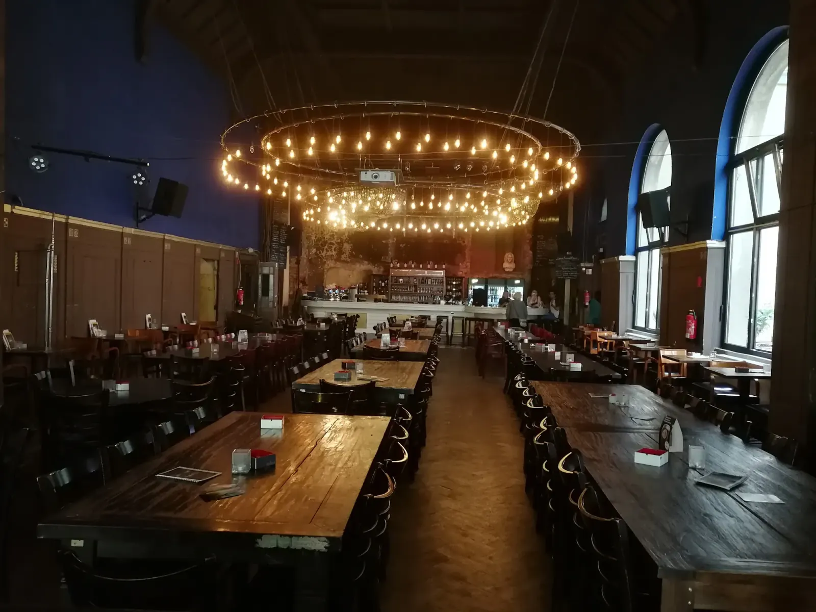 Beyerhaus grand hall interior with circular chandelier and bar at back